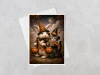 greeting card featuring a whimsical halloween bunny and kitten trick or treating displayed with a white envelope