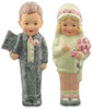 “Whimsical hand‑painted paper‑pulp couple crafted from vintage ice‑cream molds and dusted with glitter.”