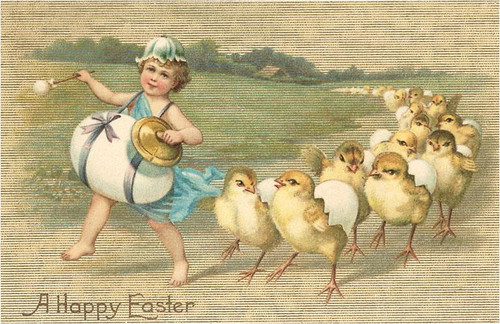 vintage easter postcard with child in blue bonnet playing drum leading yellow chicks in a grassy field