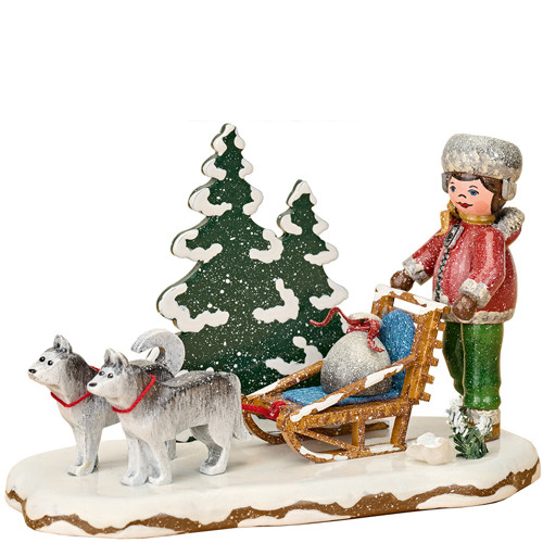 “hubrig children of the winter sled team with two huskies, red‑coated figure, and snowy trees, handcrafted erzgebirge miniature”