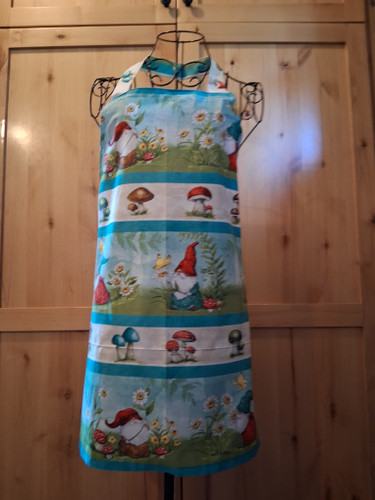Gnome and mushroom patterned cotton apron with matching head loop and ties.