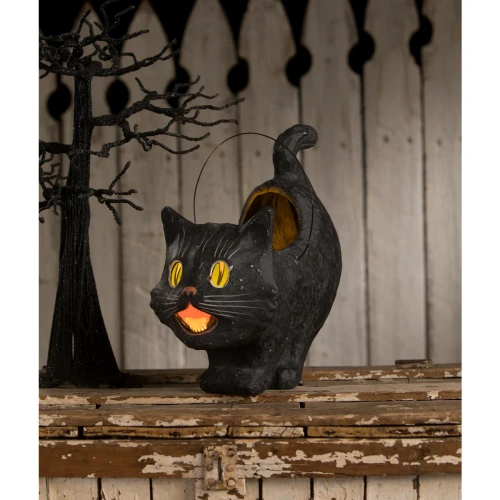 Primitive paper mâché black cat lantern with glowing vellum eyes and mouth.