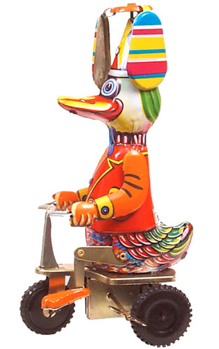 Vintage tin duck riding a scooter with spinning overhead blades
