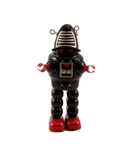 Vintage black tin robot wind‑up toy with sparking red face shield and retro box