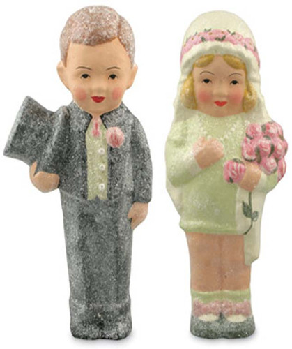 “Whimsical hand‑painted paper‑pulp couple crafted from vintage ice‑cream molds and dusted with glitter.”