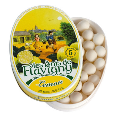 “Flavigny Lemon pastilles in a yellow vintage tin with a classic French countryside illustration.”