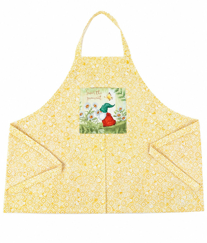 “Savor the Moment” apron, single‑sided 100% cotton with yellow daisy print and a gnome illustration.