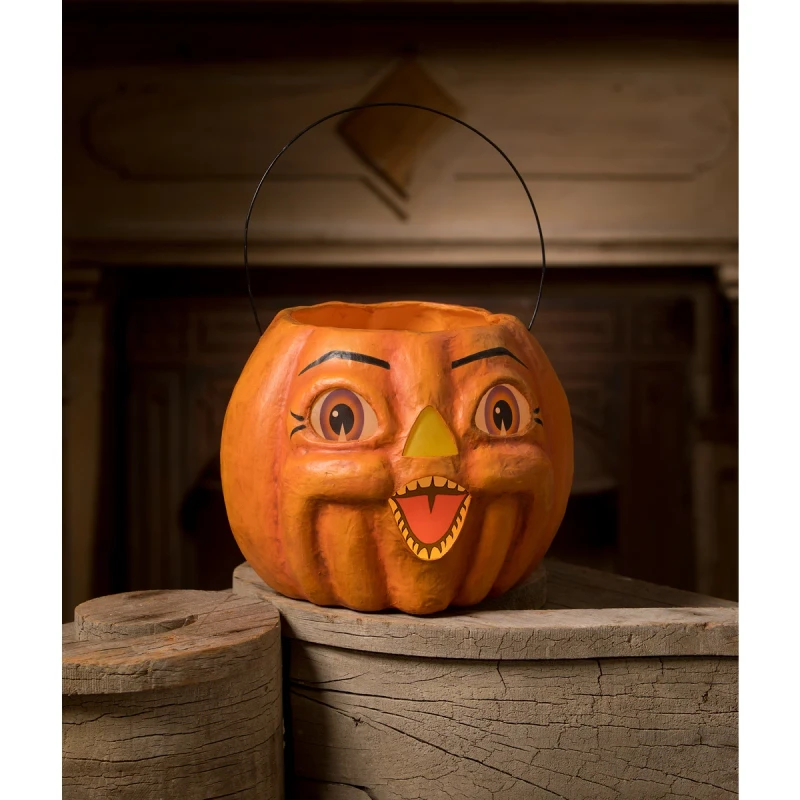 Vintage hand‑painted paper mâché pumpkin bucket with expressive face, vellum features, and wire handle.
