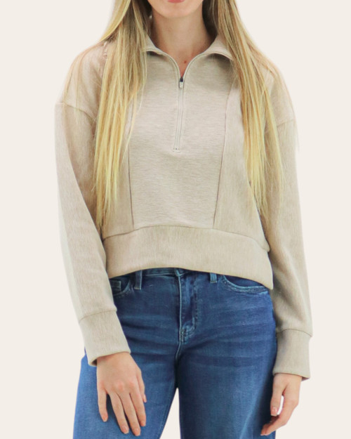 Front view of the pale beige Thread and Supply Kristine Pullover featuring a half-zip neckline and horizontal ribbed contrast.