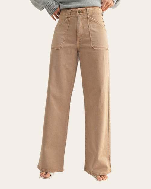 Close-up front view of high-rise tan pants with angled front patch pockets and wide-leg cut.