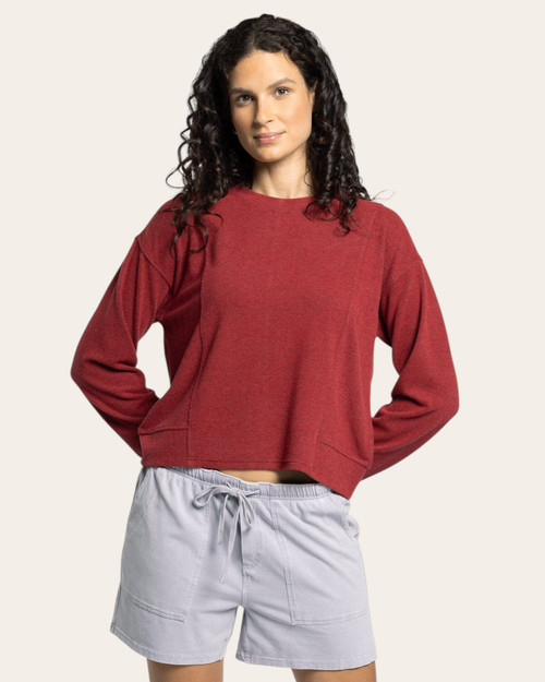 Front view of a woman in a soft crimson heather knit long sleeve top with relaxed silhouette and drawstring shorts