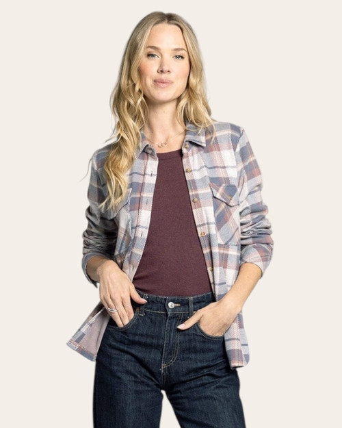 Woman casually posing in a Cassian vintage indigo plaid flannel shirt with one hand in her pocket.