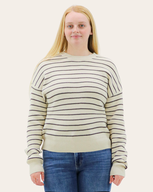 Front view of Thread & Supply Ely Sweater in cream with chocolate stripes, worn by model