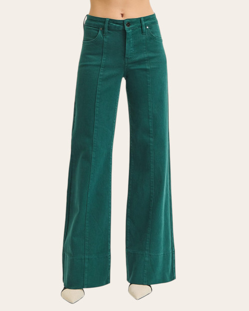 Angled front view of emerald green wide-leg pants showing detailed stitching and soft corduroy texture.