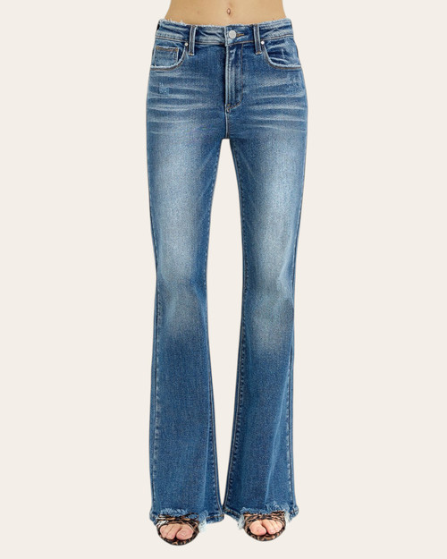 Front view of a model wearing high-rise flare jeans with subtle fading and raw hem detail.