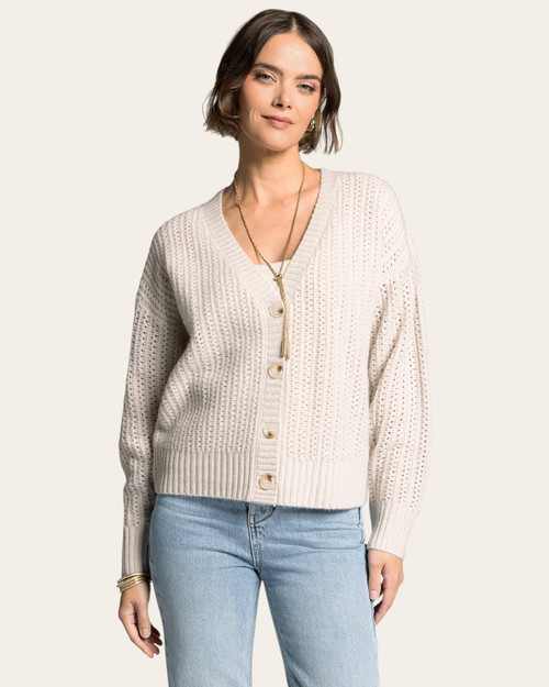 Woman wearing the Thread and Supply Amour Cardigan in Ecru with a v-neck button front, available at Trendy Threads South Dakota.