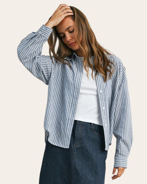 Woman wearing the Gracie Striped Button Up Top in blue and ivory with a slightly cropped fit, available at Trendy Threads South Dakota.