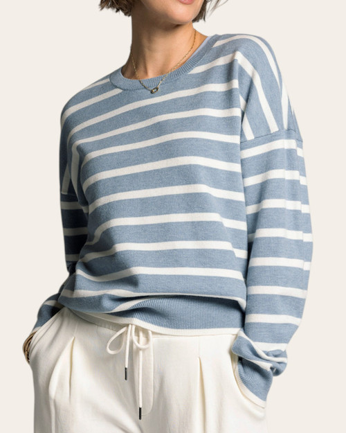 Front view of a woman wearing the ultra-soft Thread & Supply Preston crew neck sweater in dusty blue and white stripes.