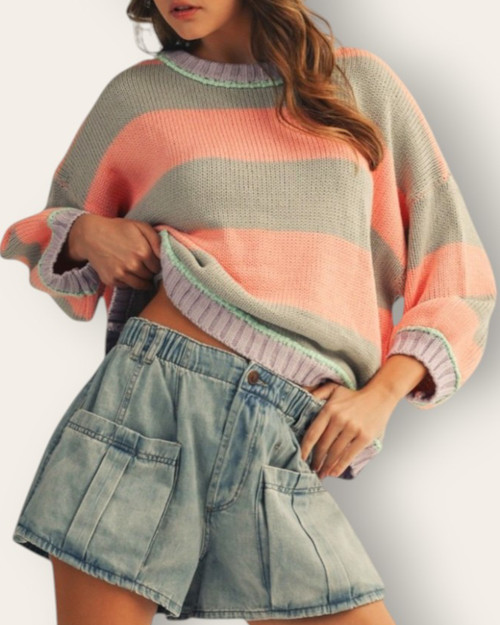 Model wearing the pastel Sunset Striped oversized sweater paired with denim, perfect for South Dakota spring weather.