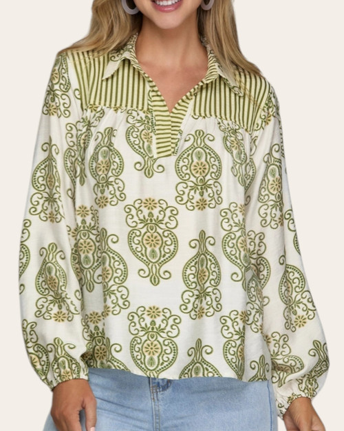 Front view of the Cassidy Printed Blouse showing the green pattern, striped yoke, v-neckline, and balloon sleeves.