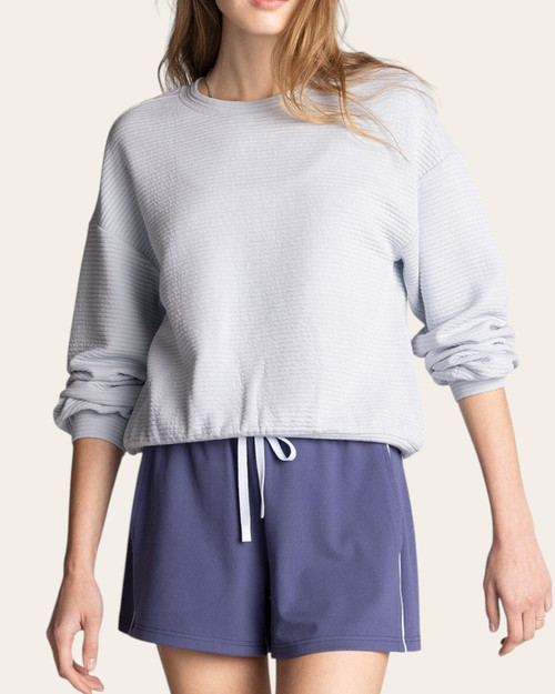 Front view of a woman wearing the Thread & Supply Dreamscape Top in Misty Blue with ribbed texture and banded hem.