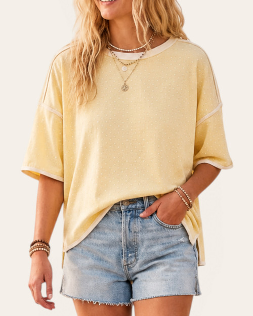 Woman wearing the oversized pale yellow Penny Polka Dot Top from our Roscoe, SD boutique, front view.