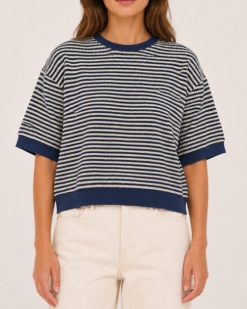 Model wearing the short sleeve striped spring knit top in navy and cream facing forward.
