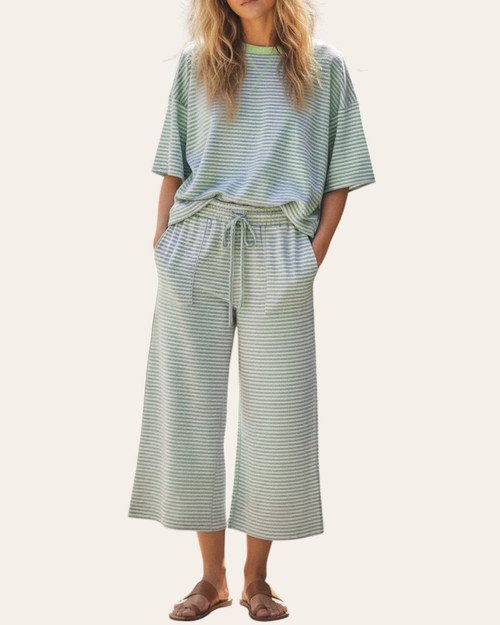 Front view of a model wearing the lightweight Kara Striped Pant Set in mint and lilac, featuring a boxy top and wide leg cropped pants with pockets.