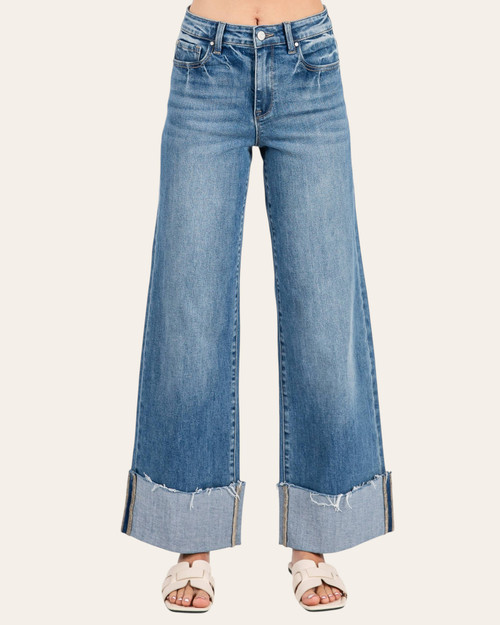 Front view of the Petra Mid Rise Wide Cuffed Jeans featuring a stylish wide leg and frayed cuffed hem.