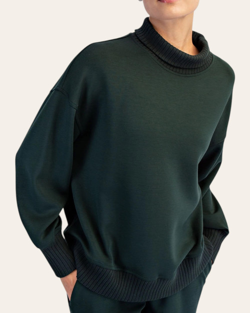 Woman modeling the front of the regency green scuba ribbed mock neck Fall pullover