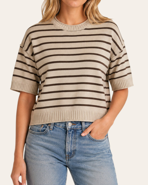 Front view of the Casey Striped Sweater worn by a blonde model, featuring an oatmeal base with black stripes and a ribbed crew neckline.