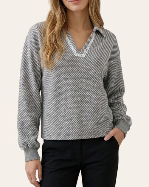 Model wearing the ash grey Blanket Stitch Collared Knit Top with a v-shaped collar and cuffed sleeves.