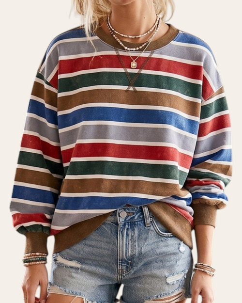 Front view of model wearing the Kassidy Mineral Washed Striped Pullover in red, blue, and green stripes.