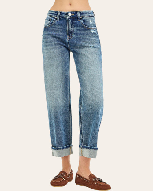 Model wearing Risen Slouchy Boyfried Jeans (Paige), front view with medium wash denim, light distressing and rolled cuffs.