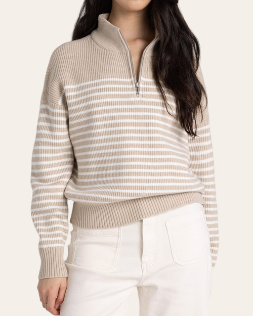 Model wearing the beige ivory Thread & Supply Russell Sweater with white pants.
