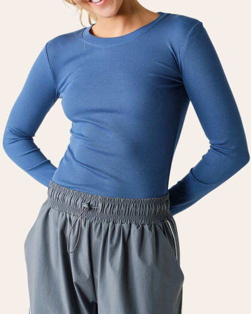 Front view of a model in the Micro Ribbed Long Sleeve Top - Ocean, showing fine vertical ribbing and long sleeves.