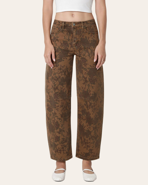 Front view of Vervet Floral Barrel Jeans on a model, showing brown floral denim, a button waistband and barrel-shaped legs.