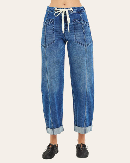 Front view of a model in Risen Slouchy Barrel Jeans (Anna), showing blue denim, a drawstring tie and sewn cuffs.