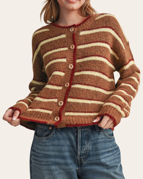 Grace Striped Cardigan - Brown/Maroon on a model holding the hem, showing the button front, cream stripes and maroon edging.
