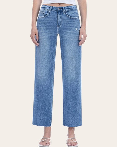 Front view of Flying Monkey High Rise Slim Wide Jeans, showing faded blue denim, light distressing and raw hems.