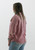 Step into spring with the effortlessly stylish 'New Beginnings Gauze Top' in a delicate pink hue, available at Trendy Threads Boutique. This top features a soft gauze fabric with a comfortable light stretch, accented with frayed seams and hem for a touch of laid-back elegance. With a full button front closure and a single chest pocket, it's the perfect blend of comfort and style. Complete with a relaxed fit that can be sized down for a more tailored look, it's modeled here with light-wash jeans and a smartwatch for a chic, casual ensemble.