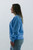 Profile view of a fashionable light blue 'Nantucket Island' graphic sweatshirt from Trendy Threads Boutique's spring arrivals, showcasing the comfortable fit and soft fabric perfect for springtime casual wear.