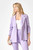 A model showcases the Just Feels Right Blazer in a delicate lavender hue, crafted from a soft and stretchy knit fabric that provides a comfortable, structured fit. The blazer features 3/4 length ruched sleeves, functional side pockets, and a timeless notched lapel, designed to offer versatility and elegance. Whether paired with coordinating pants for a monochromatic ensemble or dressed down with a casual tee and denim, this blazer is a season's must-have for effortlessly chic style.
