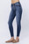 Side view of high-waisted skinny jeans showing the contour of the side seam, a five-pocket design, and a close fit through the thighs and calves, ending in a cuffed hem above the ankle.