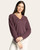 Front view of a woman wearing a cozy wine heather v-neck knit top with cuffed sleeves and relaxed fit