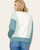 Back view of a women's green and cream pullover with diagonal stripe panel design and relaxed fit.