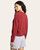 Back view of a woman wearing a crimson heather knit long sleeve top with relaxed drop shoulders and curved hem