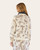 Back view of a cream-colored western print crewneck sweatshirt featuring cowboys, horses, cacti, and boots, styled for relaxed loungewear.