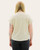 Back view of a light textured short-sleeve knit top with rolled sleeves, shown on model with long straight hair and black jeans.