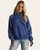 Front view of Jessa Quarter Zip Sweatshirt – Navy — casual women’s blue quarter zip sweatshirt styled with light-wash jeans.